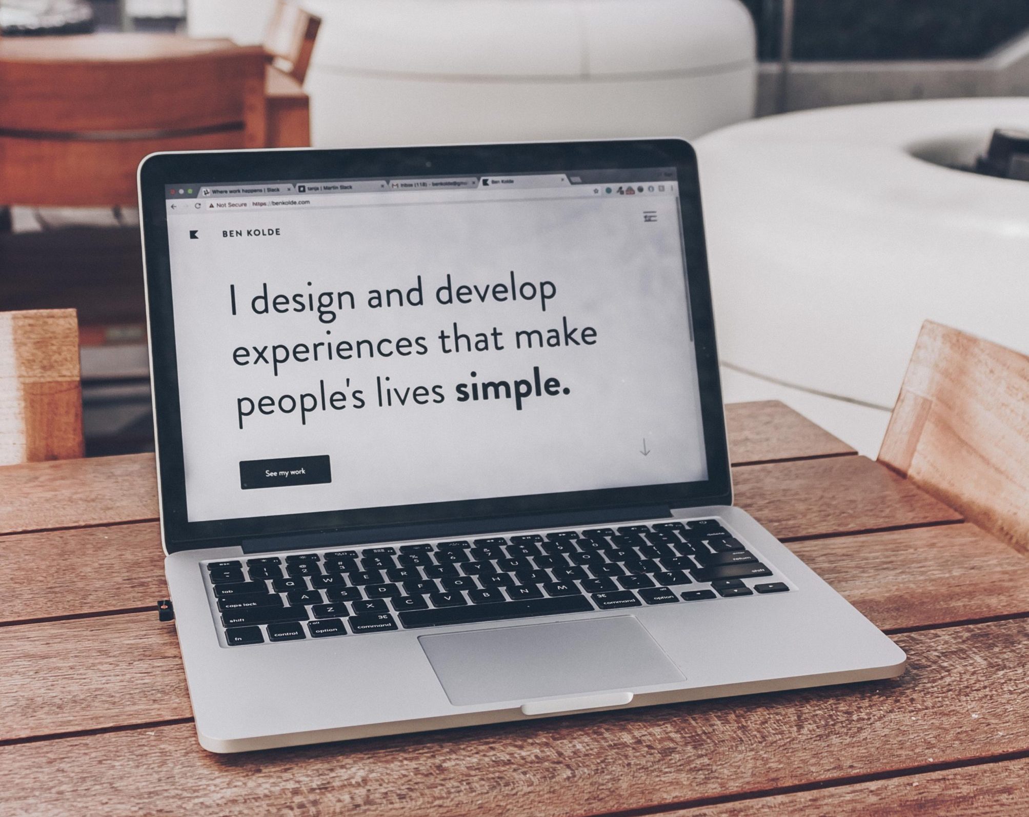 Image of open laptop computer with text: I design and develop experiences that make people's lives simple.