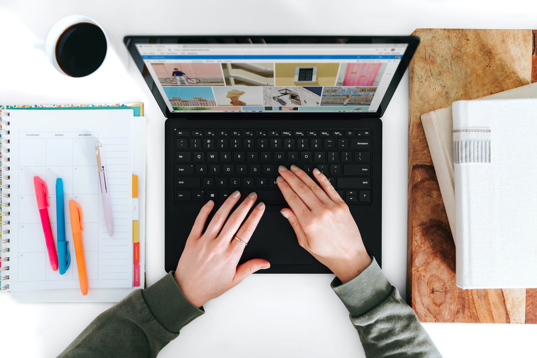 Laptop from above with two hands on the keyboard.