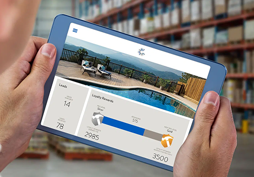 Person holding a tablet displaying a poolside dashboard with leads, loyalty rewards, and progress bars.