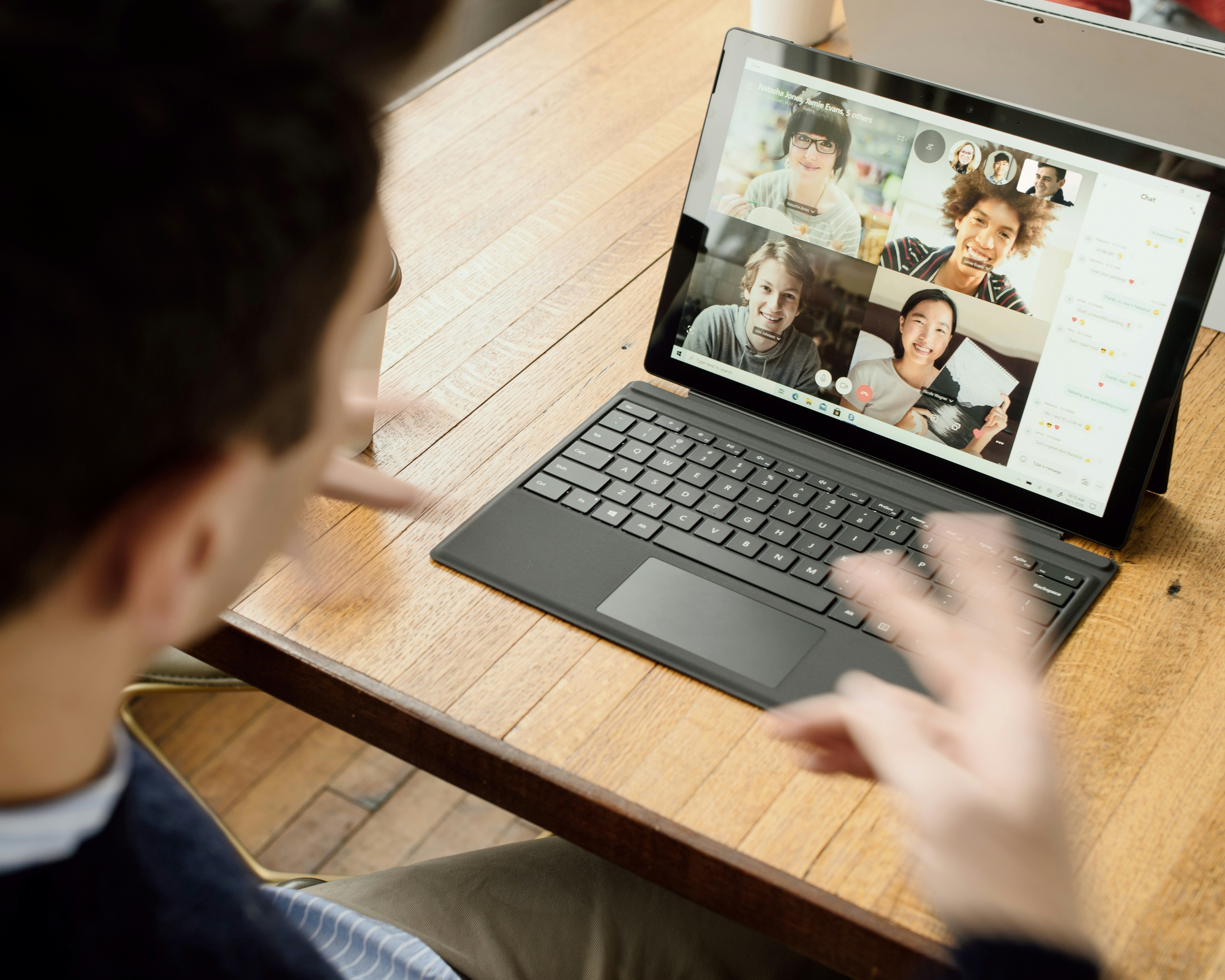 person attending remote meeting on laptop